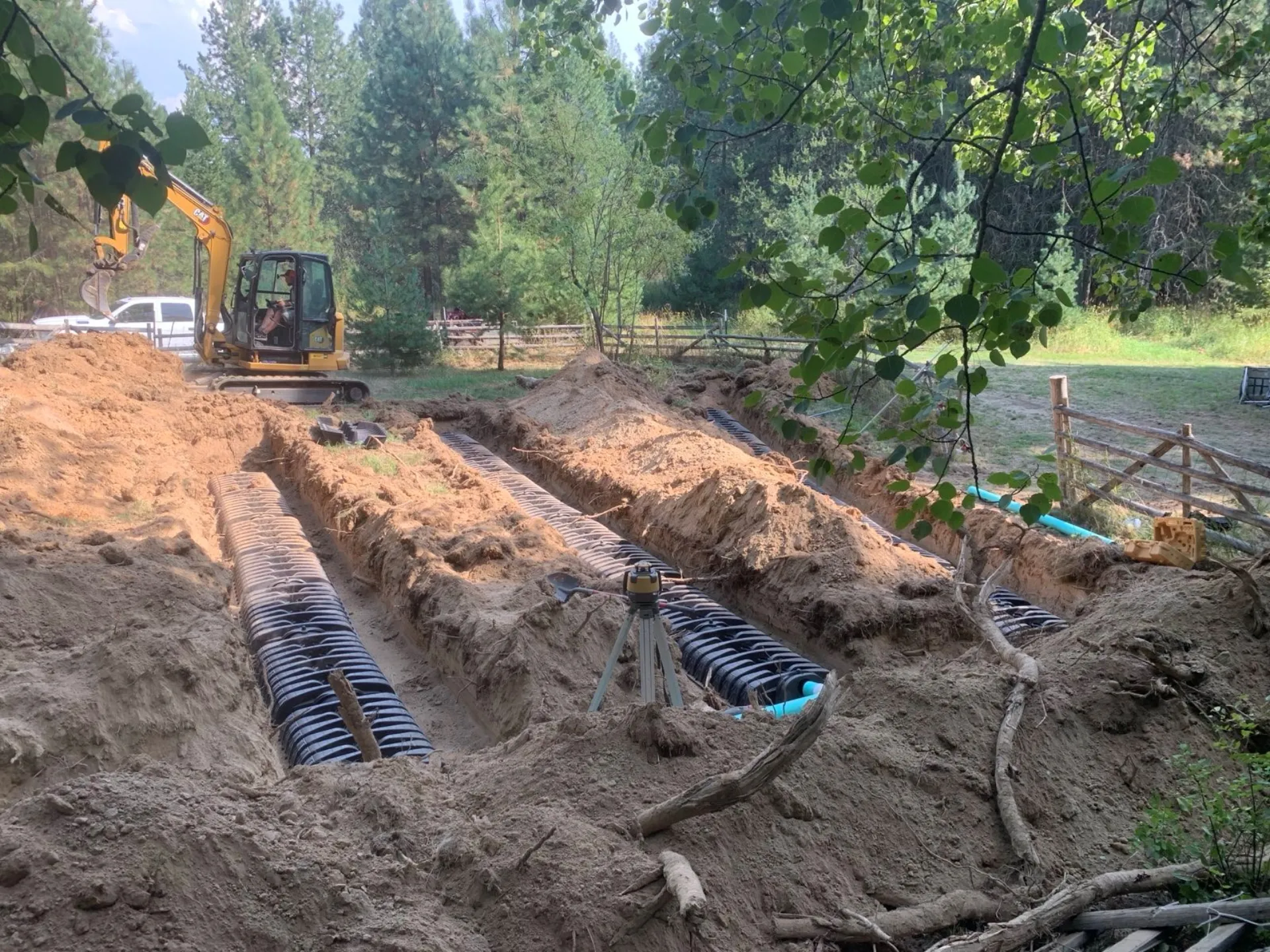 Septic system installation with drain field trenches