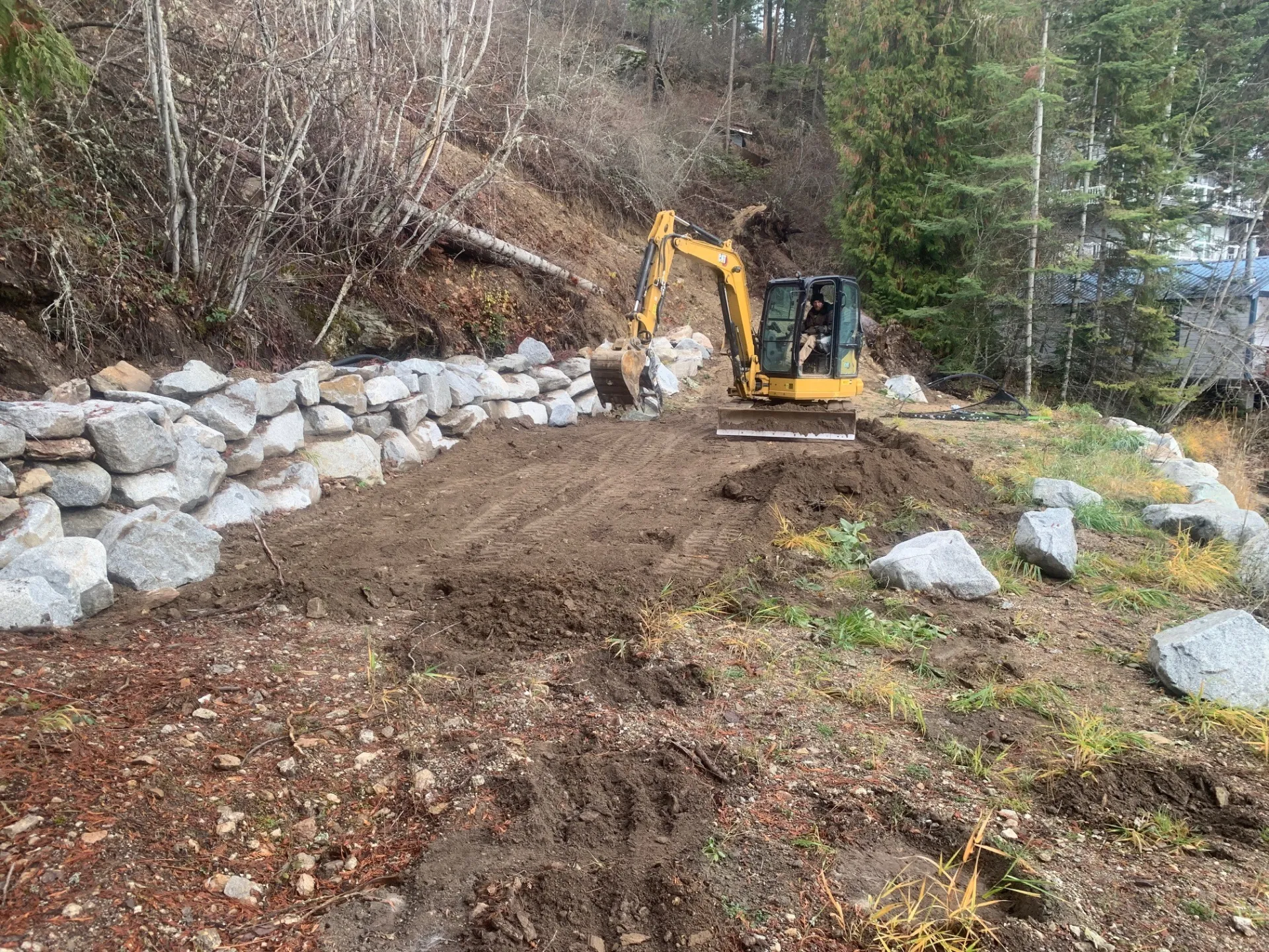 Site preparation with excavator clearing land in North Idaho